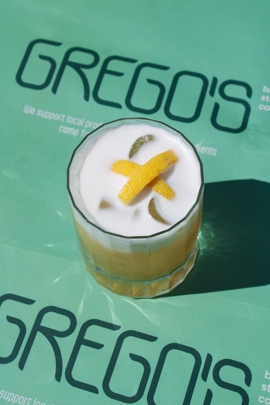 Gregos signature cocktail on branded placemat