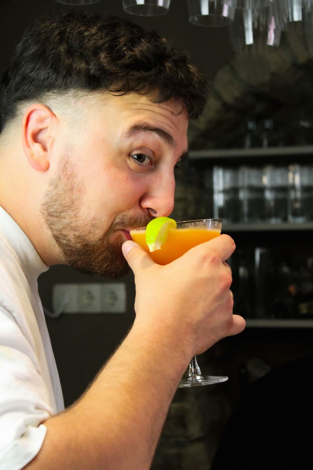 Bartender tasting a fresh citrus cocktail